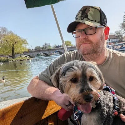 Tim Youngman on a boat on the river at Stratford-upon-Avon, with Ziggy the dog